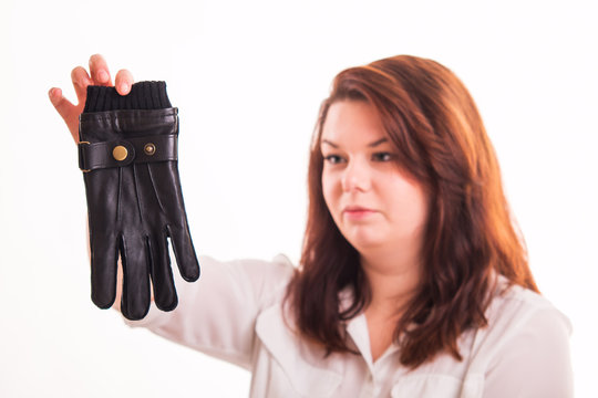 Woman holding black leather glove
