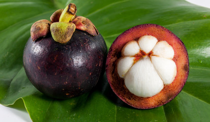 The mangosteen on t he  leaf and blur background.