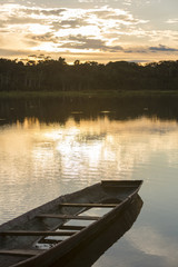 Obraz premium Sunset on a lake with canoe, Madidi National Park. Bolivia