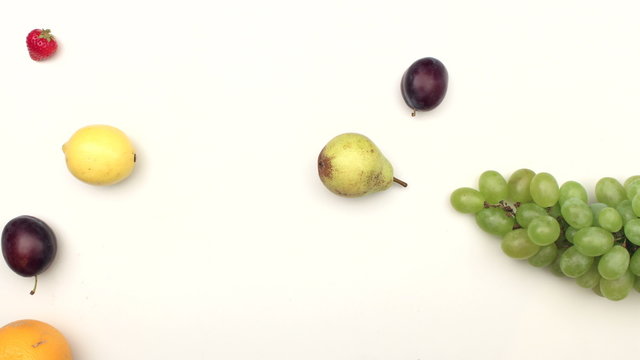 Fresh fruits moving on white background - stop motion animation