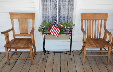 Two old wooden chairs on rustic old porch