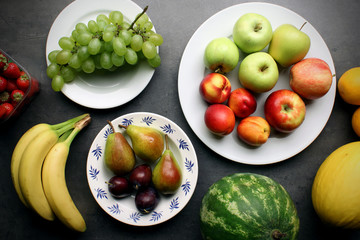 Fresh fruits on kitchen table background. Healthy eating concept.