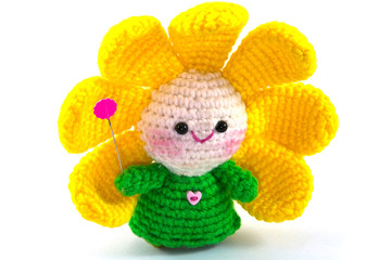 Happy baby flower, handmade crochet doll on white background 
