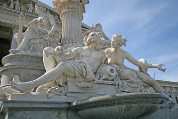 Statues of the fountain in front of the Austrian Parliament in Vienna, Austria. Sculptures represent rivers Danube and Inn