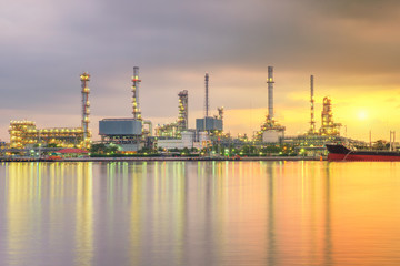 Obraz na płótnie Canvas Oil tank ship mooring in oil refinery industry at twilight time