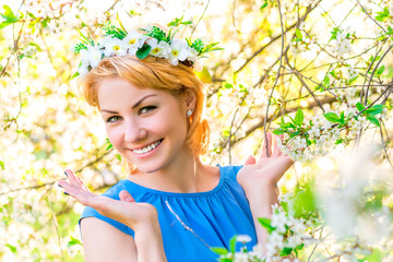 Horizontal portrait of happy blond in cherry blossoms