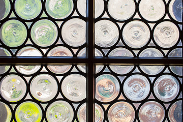 Medieval window with circular panes of swirled glass, Europe.