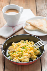 Scrambled egg with bread and coffee.