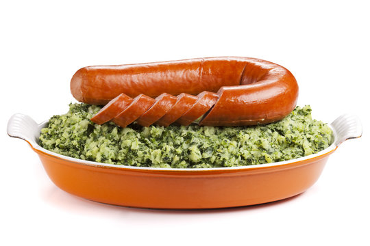 Dutch food: 'Boerenkool met worst' on a white background
