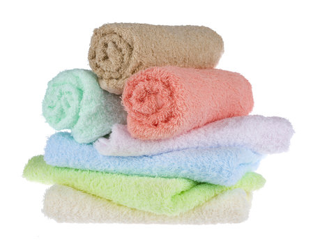 Terrycloth towels arranged in a stack on white background