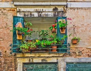 Fototapeta na wymiar Window in an old house decorated with flower