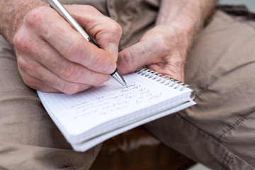 Man taking notes on a pocket book
