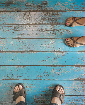 Feet on blue wooden background