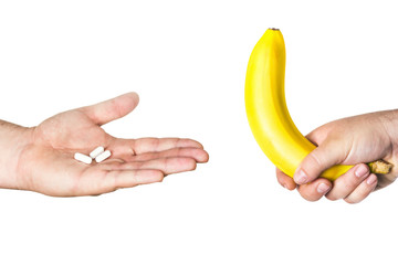pills and big banana in man's hands - obrazy, fototapety, plakaty