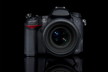 DSLR camera front on black background