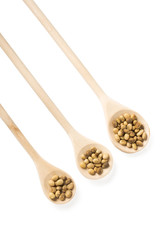 Soybeans in a wooden spoons on white background