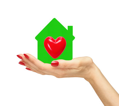 Female hand with small model of house with red heart isolated on