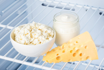 dairy products on the shelf in the refrigerator