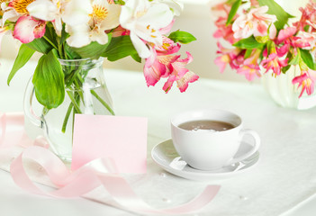 Fototapeta na wymiar Beautiful bouquet of alstroemeria and cup of tea for mother's da