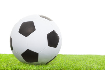 Fototapeta na wymiar soccer ball on green grass isolated on white