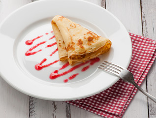 folded pancake on white plate