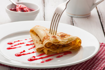folded pancake on white plate