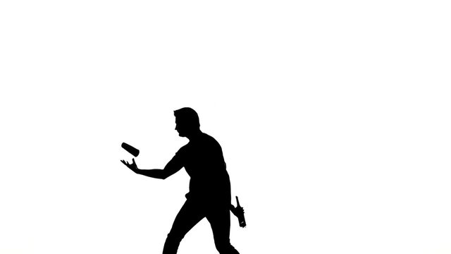 silhouette of barman man showing tricks. slow motion
