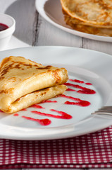 folded pancake on white plate