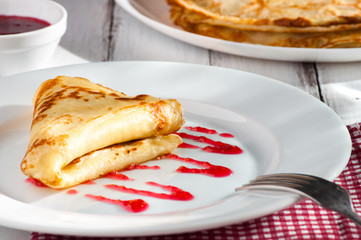 folded pancake on white plate