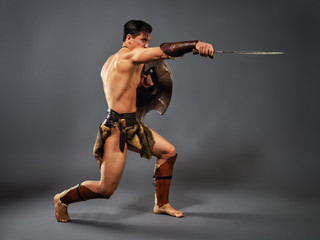 Fototapeta na wymiar Ancient warrior. Blow with a sword
