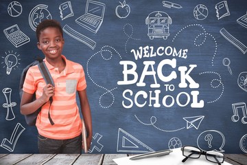 Composite image of portrait of happy cute boy in library