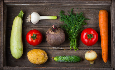 Set of different fresh raw vegetables in an old wooden box