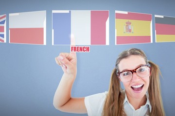 Composite image of happy geeky hipster pointing 