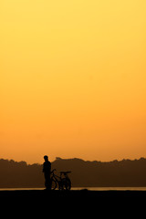 Silhouette of cyclist at sunset.