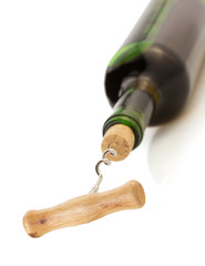 corkscrew and wine bottle on white