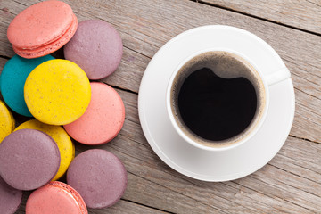 Colorful macaron cookies and cup of coffee