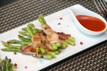  Asparagus wrapped in bacon with italian sauce
