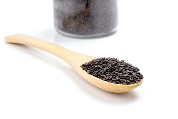 Heap of black sesame on wooden spoon