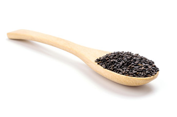 Heap of black sesame on wooden spoon