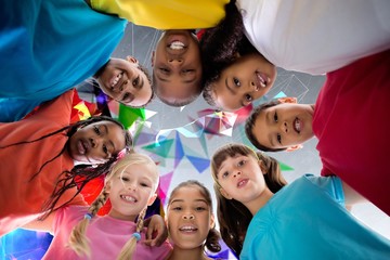 Fototapeta premium Composite image of elementary pupils smiling