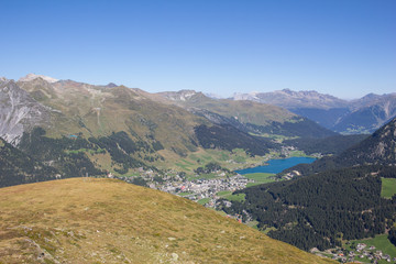 View From Mt. Jakobshorn Down To Davos & Lake Davos In Graubünden In Switzerland In Summer