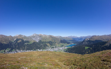 Fototapeta na wymiar View From Mt. Jakobshorn Down To Davos & Lake Davos In Graubünden In Switzerland In Summer