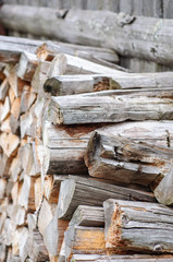 Stack of firewood near fence