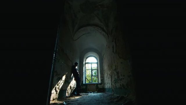Young man in despair goes to an abandoned house. Concept: job