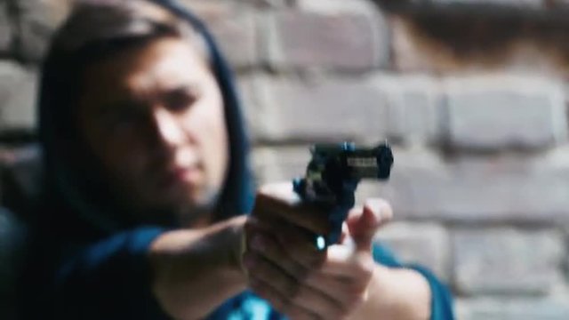 Teenager shoots a gun. Concept: crime, dysfunctional families