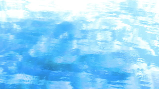 Blue water surface mirroring the sky