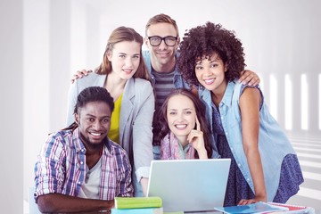 Composite image of fashion students working as a team 