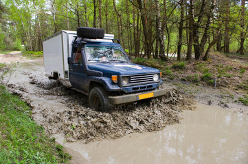 Obraz na płótnie Canvas Four wheel drive on muddy track