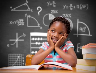 Composite image of pupil sitting at her desk 