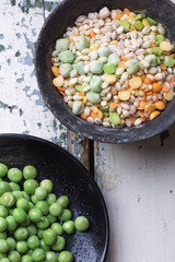 Quinoa Burger ingredients: quinoa, mangold, dry grain mix, chili pepper, eggs green peas basil on white rustic board